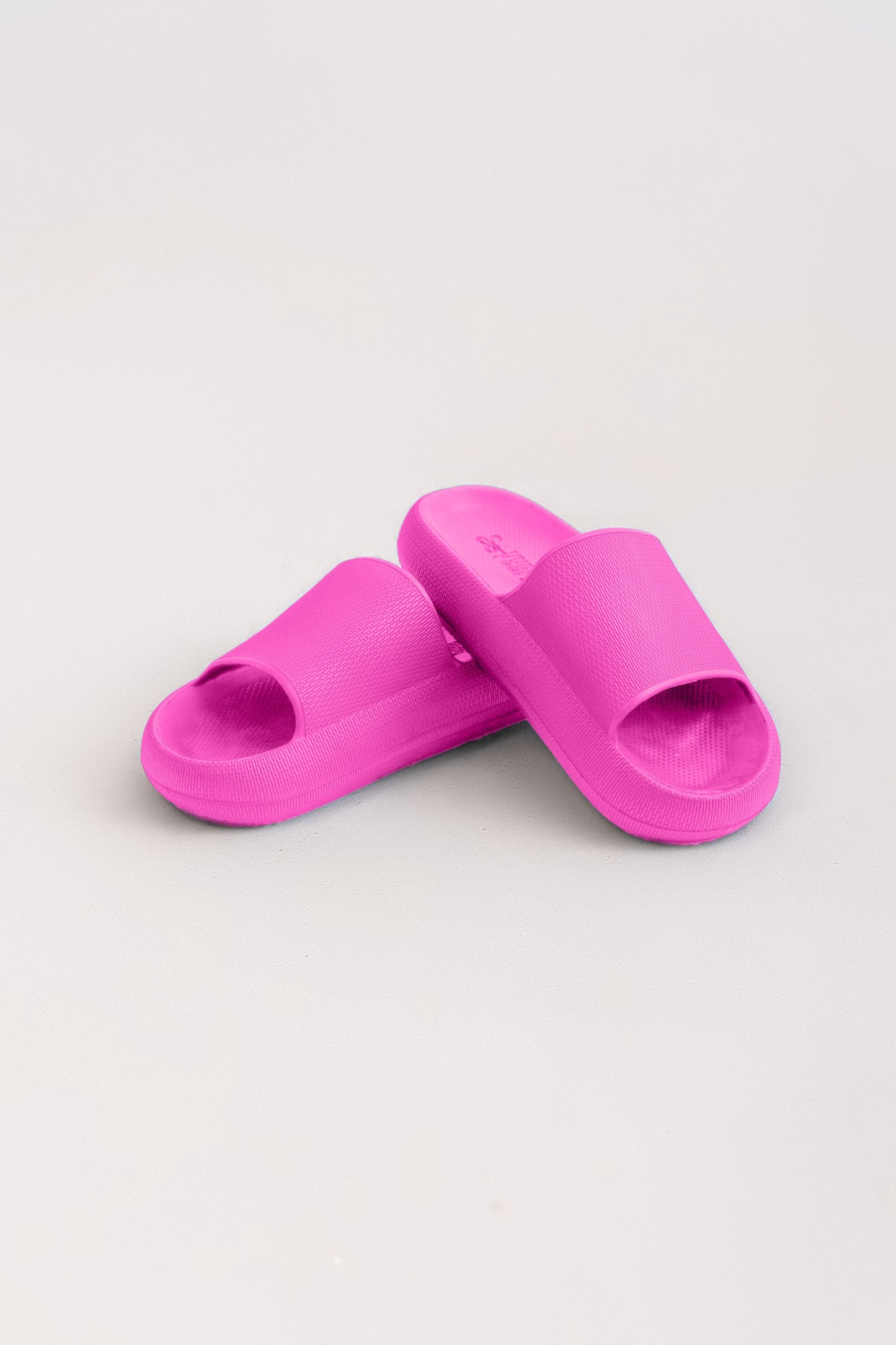 Pair of pink slides on a light gray background
