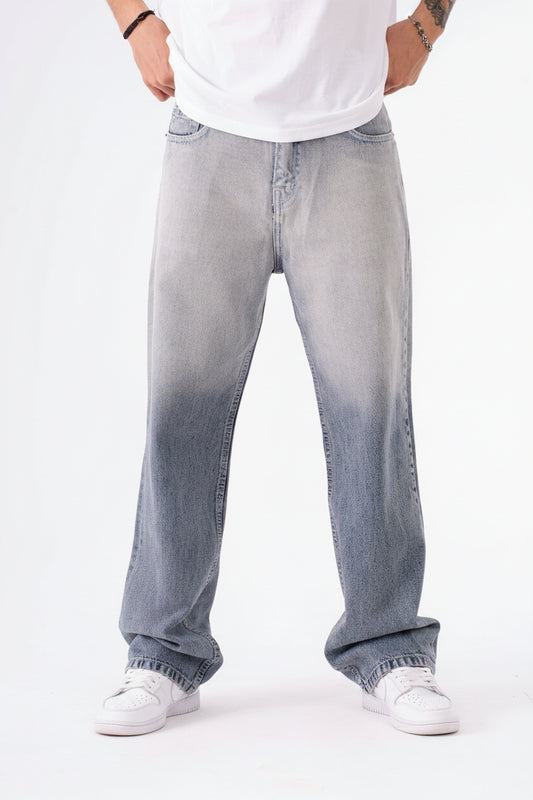 Person wearing light blue in dark blue jeans on a white background