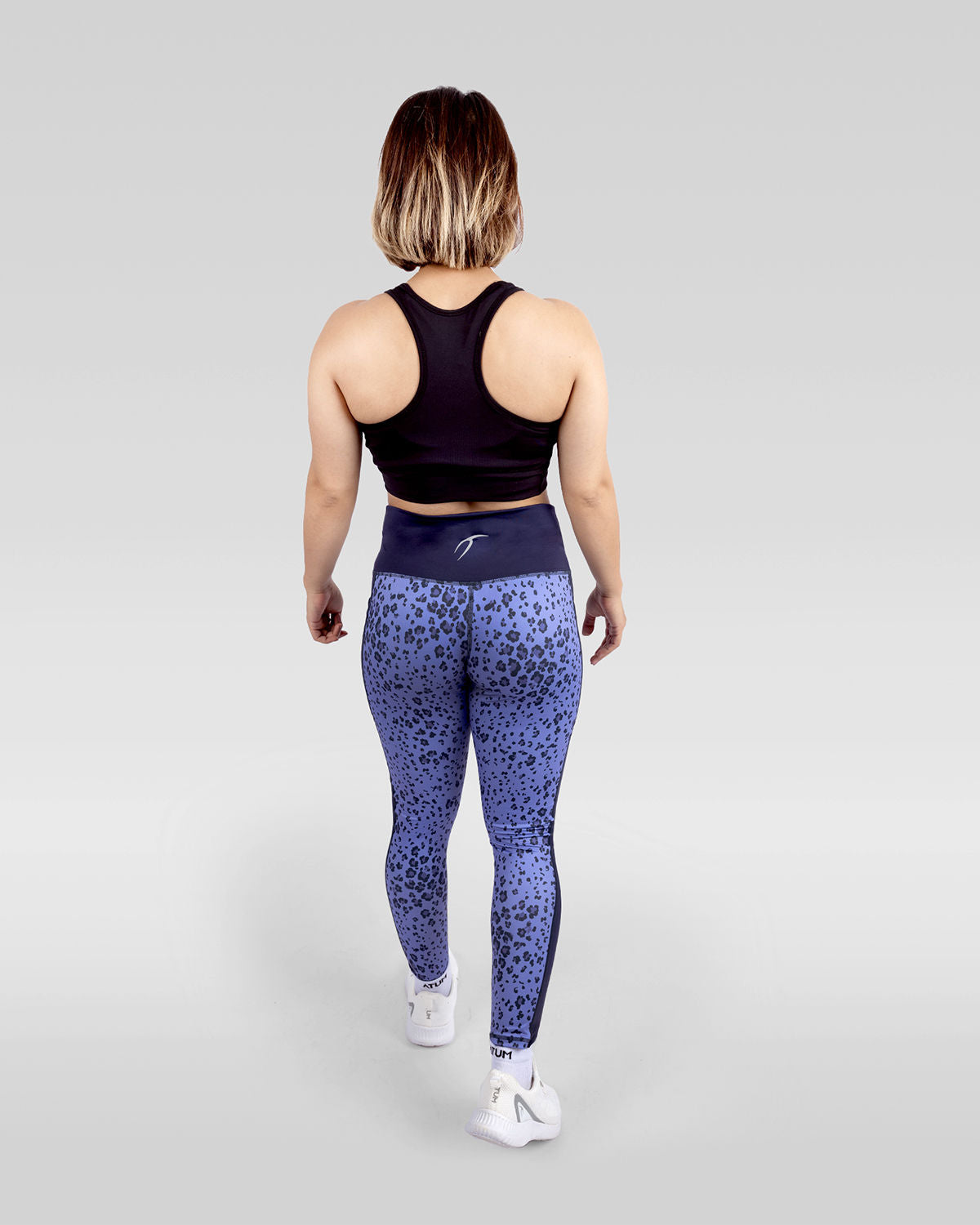 Photo by ð—”ð—§ð—¨ð— SPORTSWEAR Â® on December 20, 2022. May be an image of 1 woman wears printed purple/navy floral leggings, and black sports bra with white shoes.