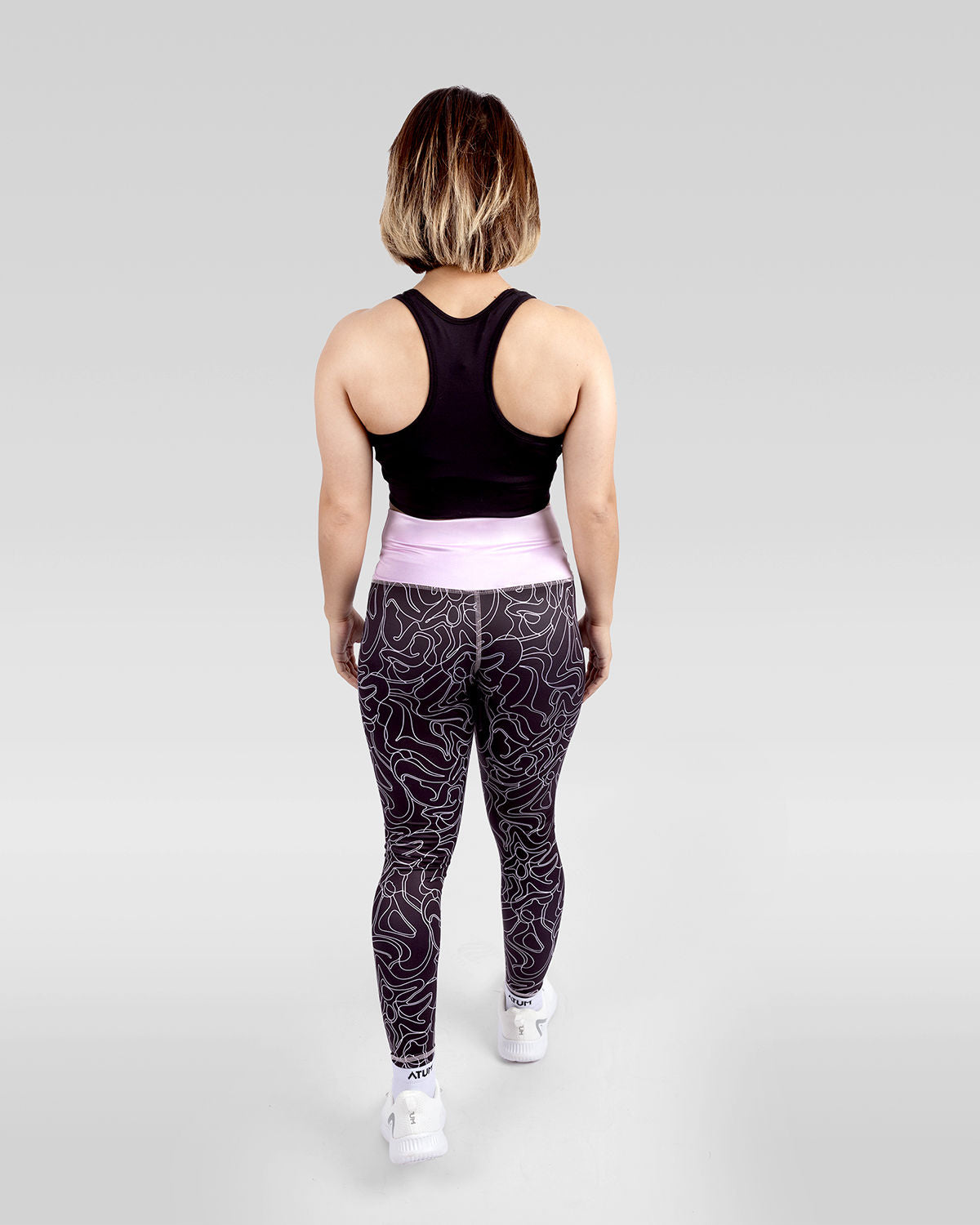 Photo by ð—”ð—§ð—¨ð— SPORTSWEAR Â® on December 20, 2022. May be an image of 1 woman wears rose printed leggings, black sports bra ,and white shoes.