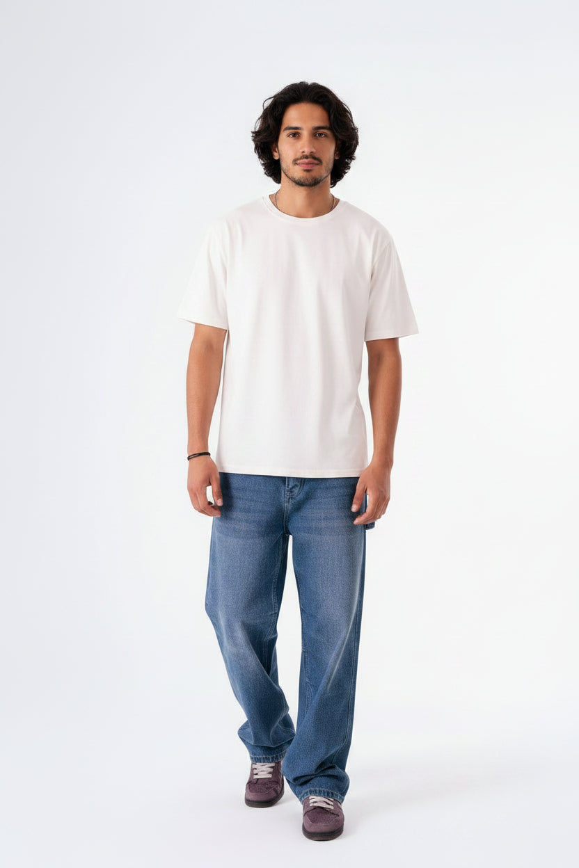 Man wearing a white t-shirt and blue jeans on a white background