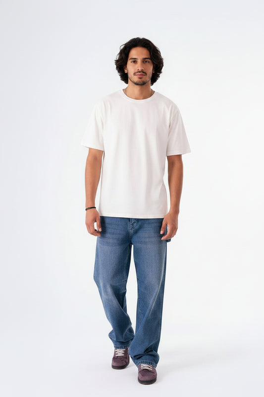 Man wearing a white t-shirt and blue jeans on a white background