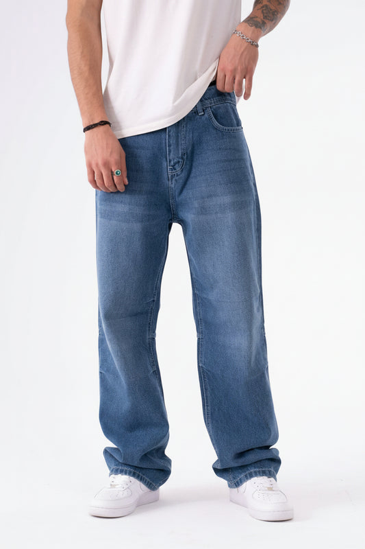 Person wearing blue jeans on a white background