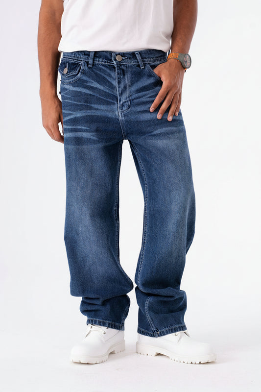 Person wearing blue jeans and yellow work boots on a white background