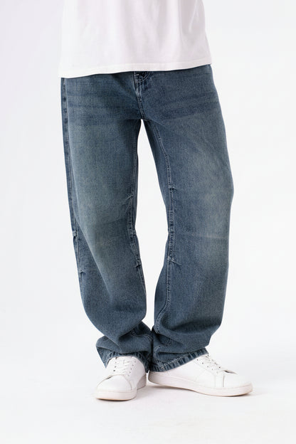 Blue jeans worn by a person on a white background