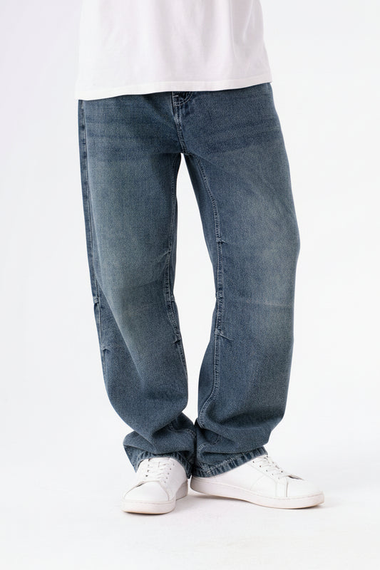 Blue jeans worn by a person on a white background